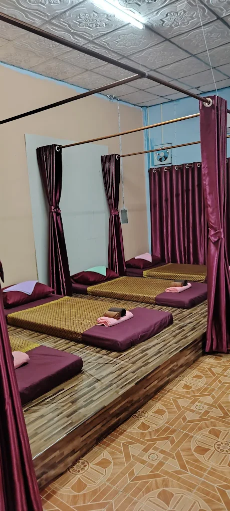 Interior view of massage stations with private curtains and wooden platform