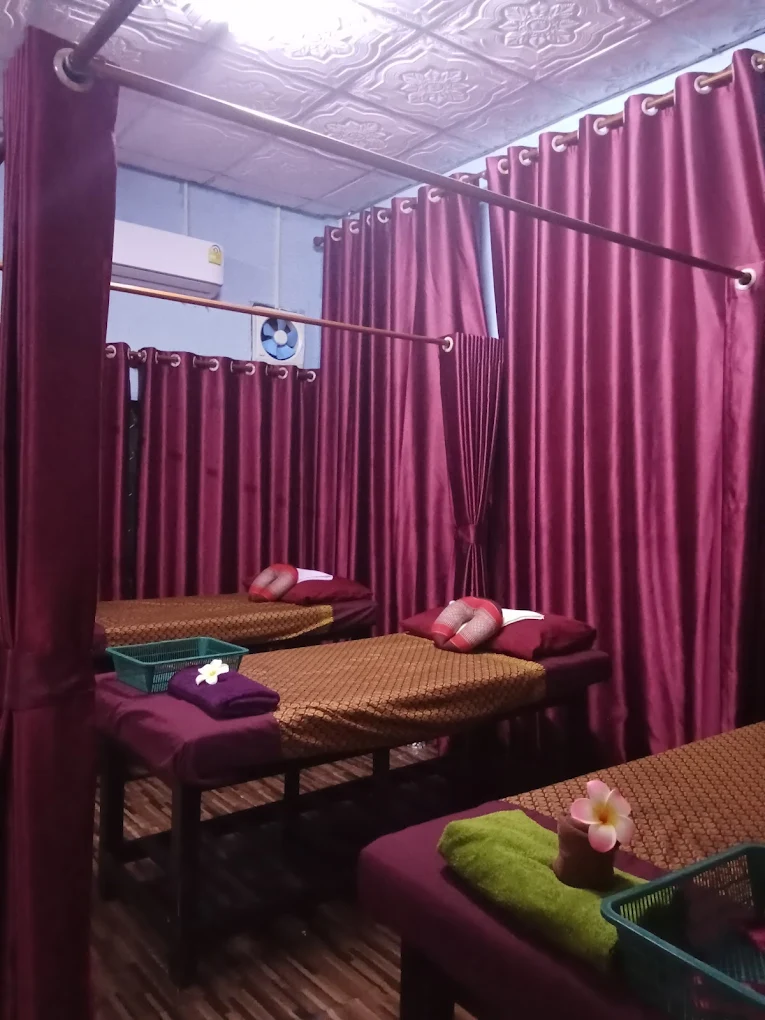 Massage room with three massage beds separated by curtains