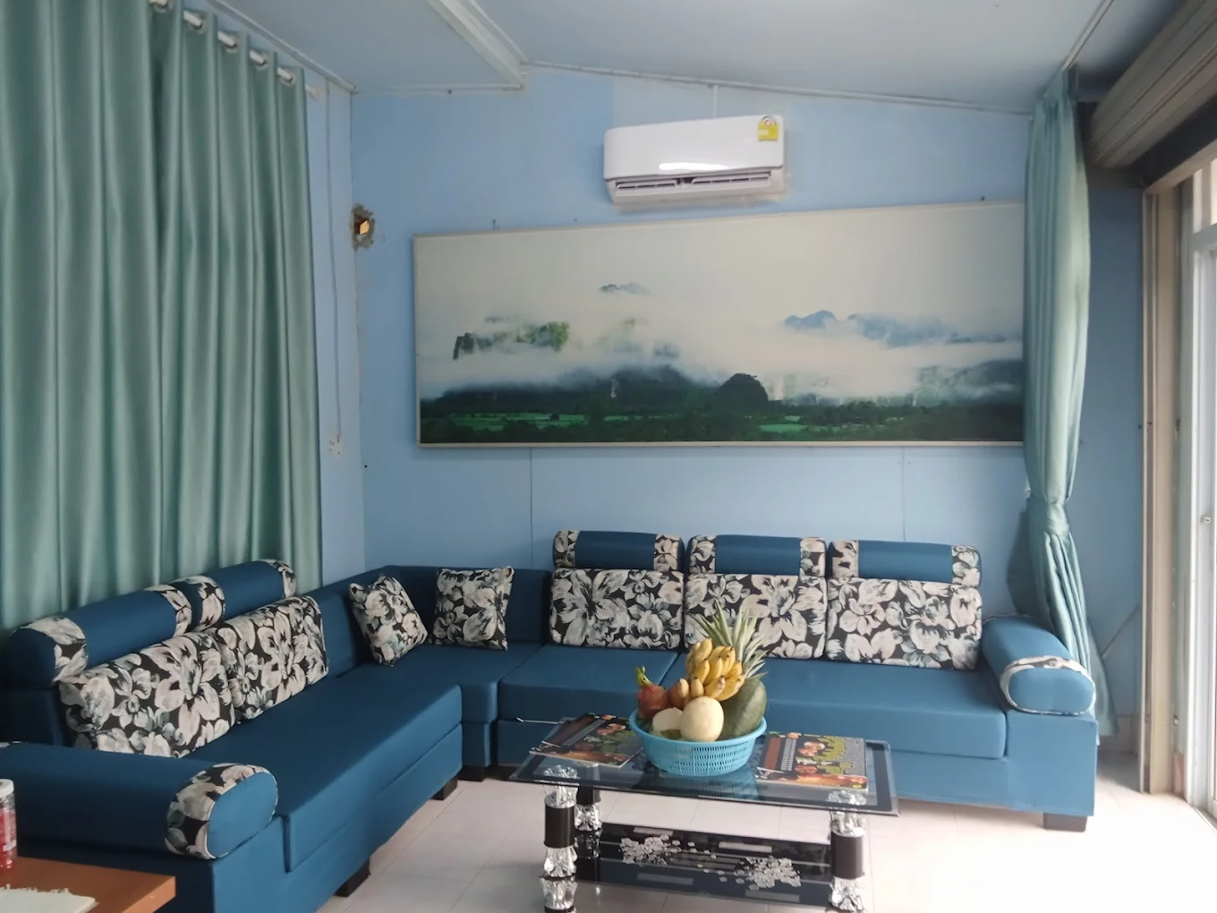 Relaxing lounge area with turquoise seating and mountain view art